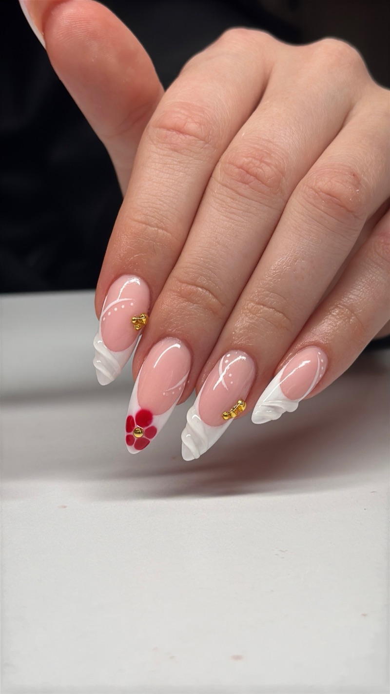 White French tips with a red flower accent
