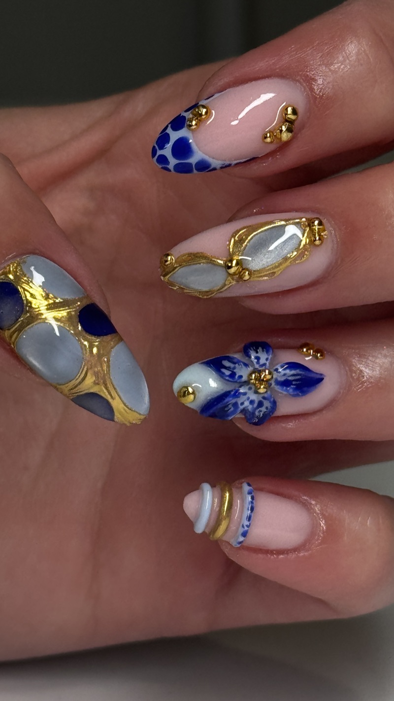 Blue and white floral nails with gold detailing