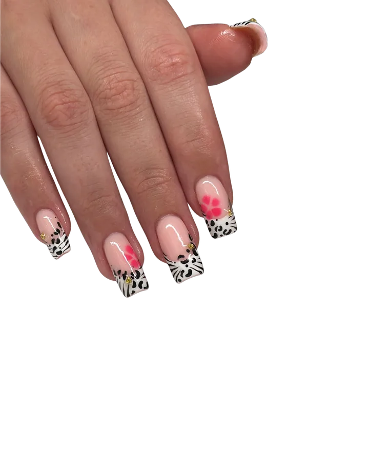 Leopard print French tips with a pink flower and gold charms